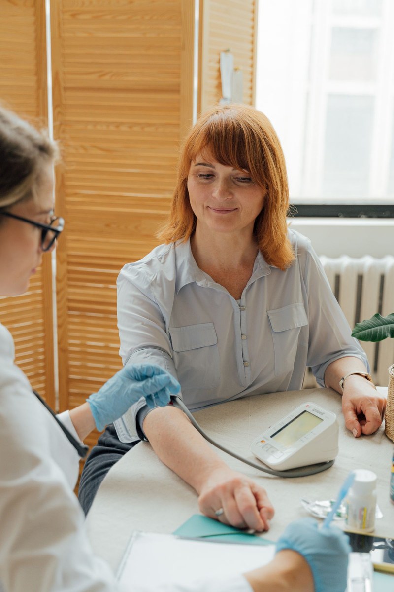 Digital blood pressure monitor on a clinic table during a routine checkup